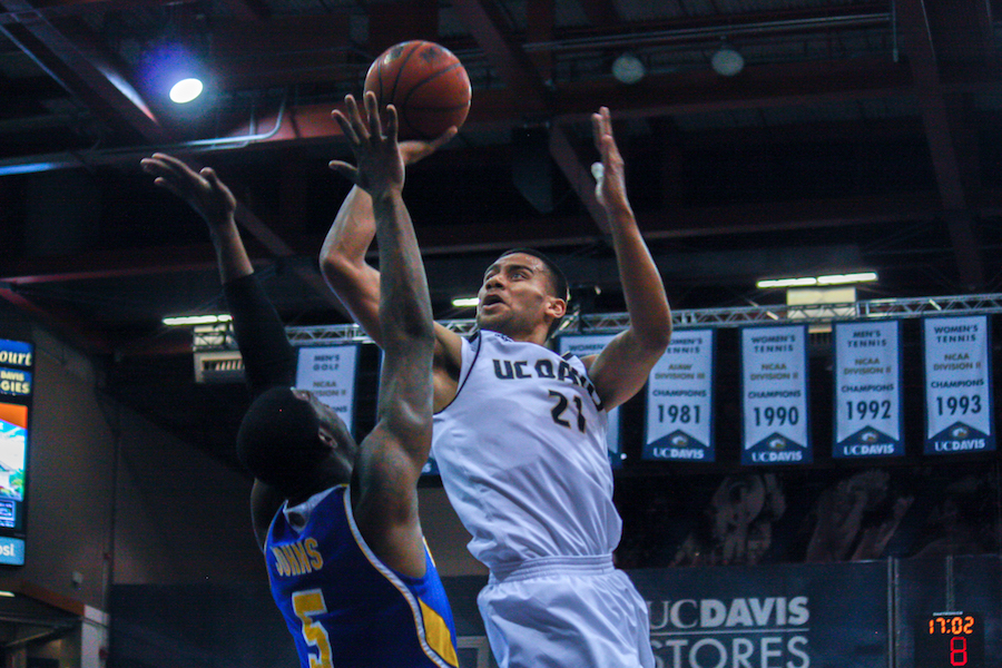 Josh Fox scores 20 points against UC Riverside while engaging in small competition with another Daly City native Taylor Johns. (DEVIN McHUGH / AGGIE)