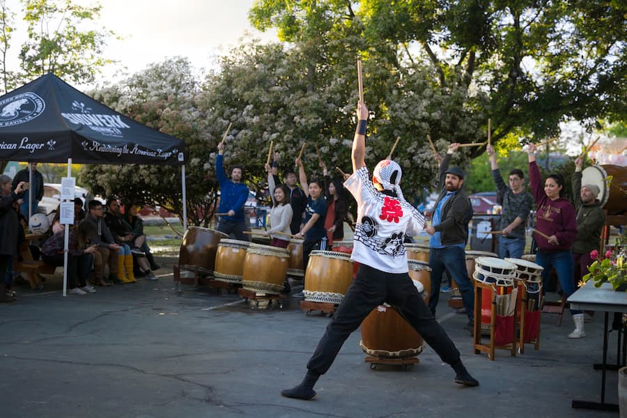 A member of Bakuhatsu Taiko Dan leads a hands-on drumming session at the Davis Cherry Blossom Festival. (DIANA LI)
