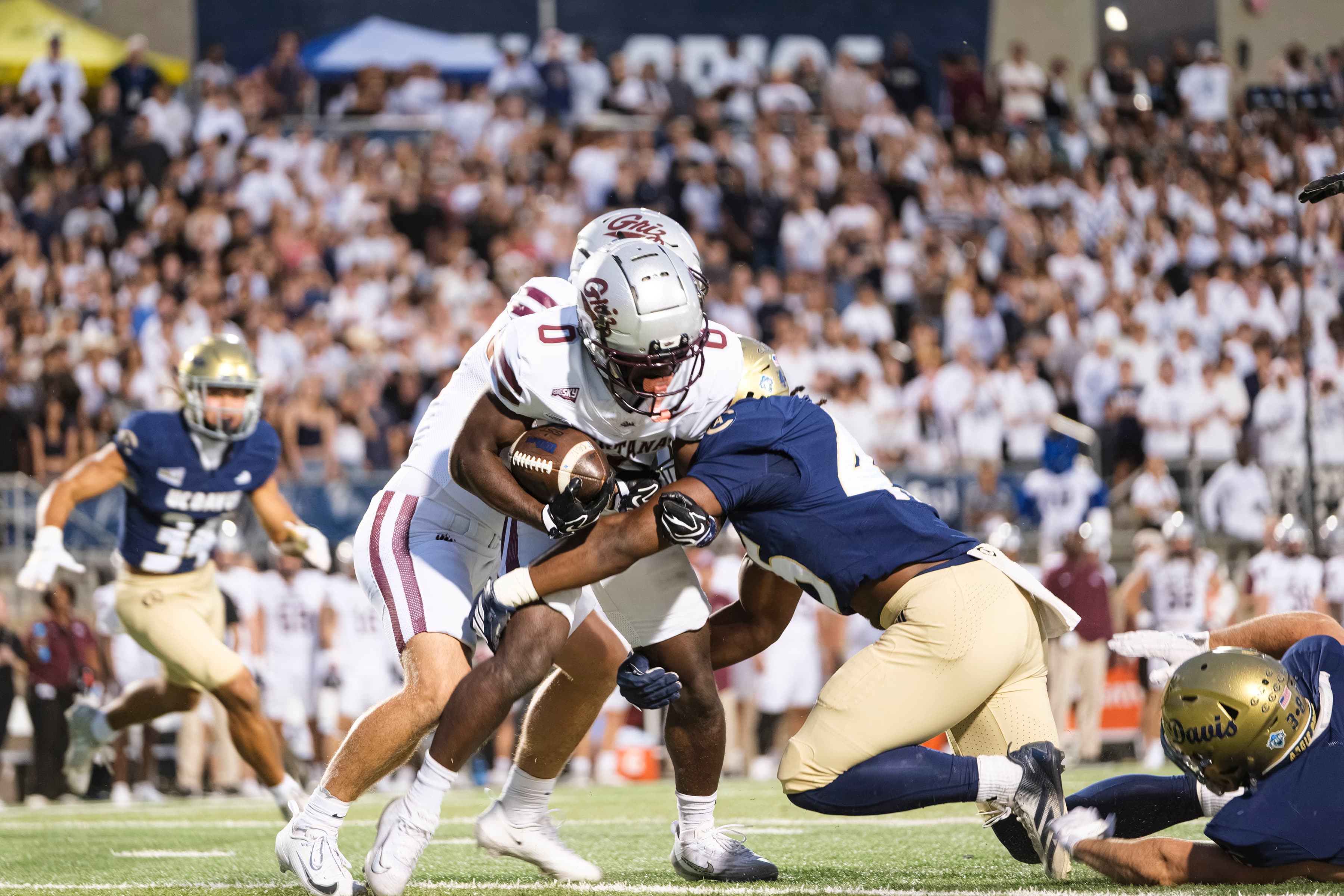 UC Davis linebacker Rickey Johnson (45) tackles the ball carrier during the game against the University of Montana on Sept. 26. (Grant Judkins / Aggie)