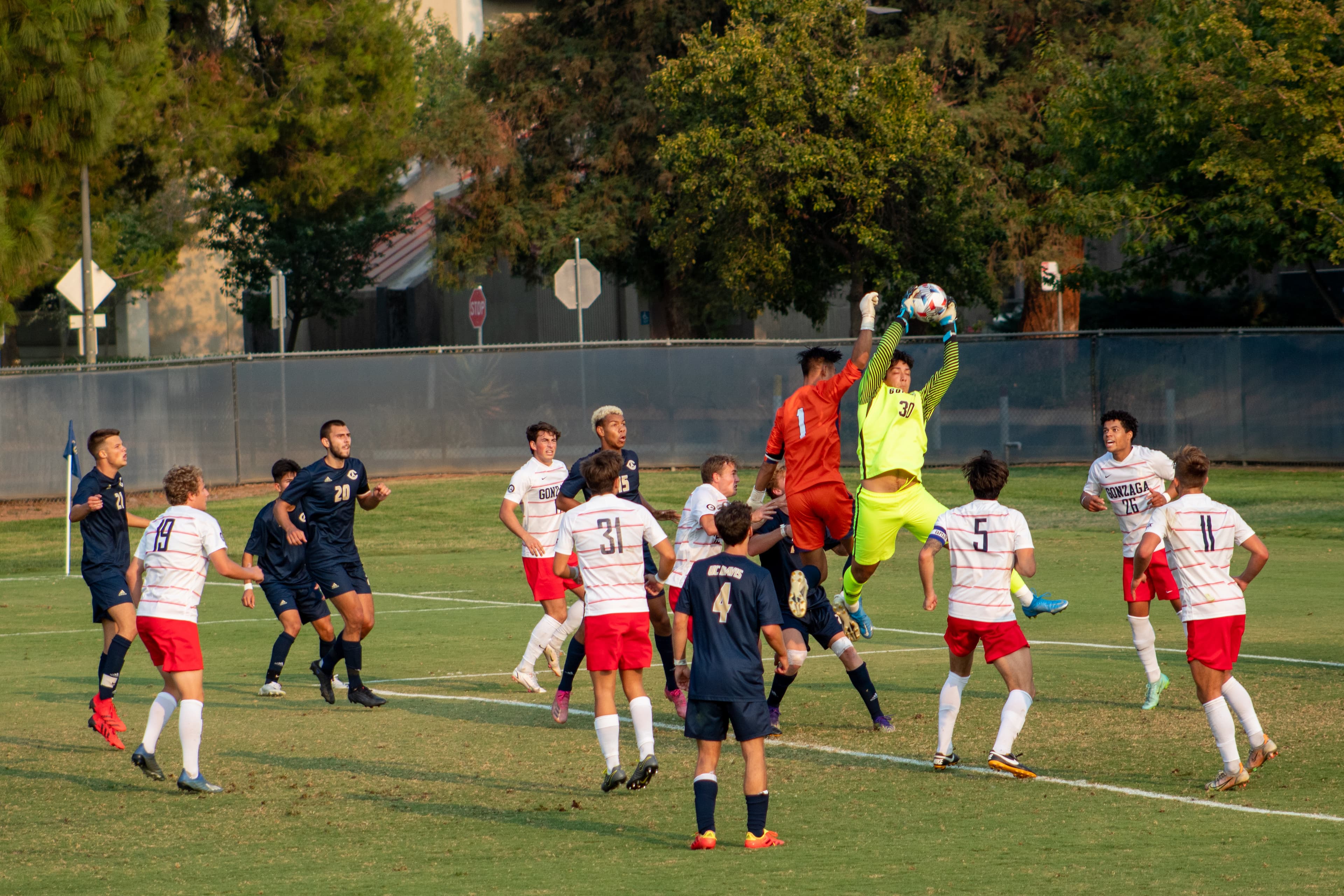 UCD men's soccer team out on the field mid-play