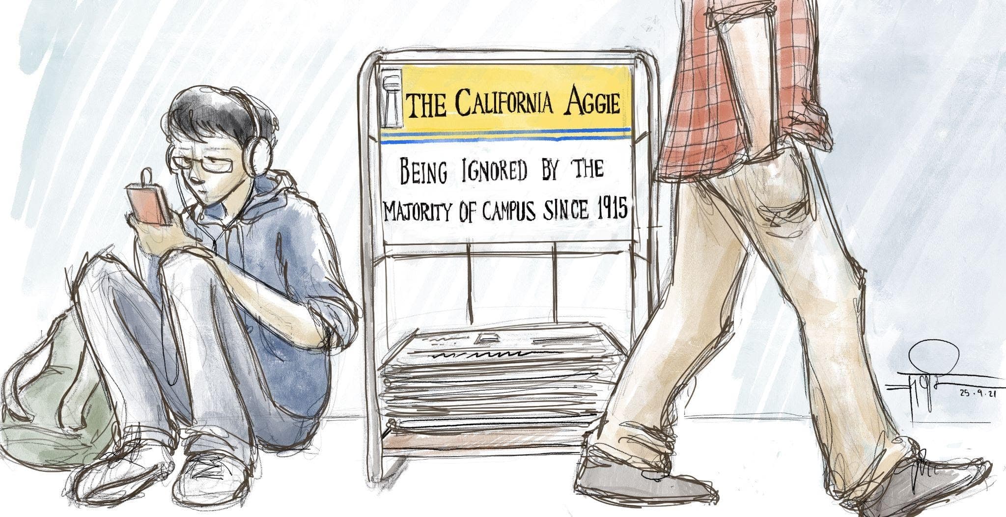 Students walking past The California Aggie stand. Text reads "The California Aggie. Being ignored by the majority of students since 1915."
