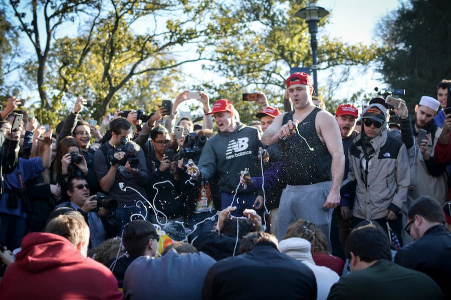 Milo Yiannopoulos and his supporters pose as protesters while volunteers spray them with aerosol string, recreating the scene of the 2011 UC Davis ppper spray incident. (DIANA LI / AGGIE)