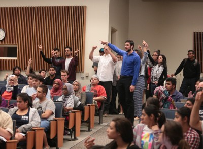 Members of the public react to a statement made by a speaker during the Business and Finance Commission meeting. Photo by Brian Nguyen.