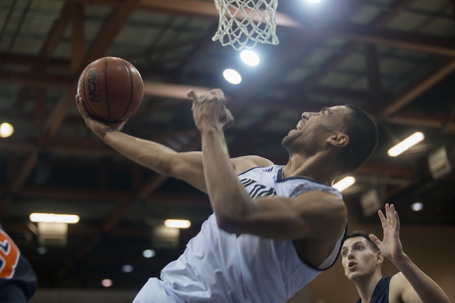 Senior forward Josh Fox goes in for a layup to lead the game with 21 points against Fresno Pacific, two shy of his career high. (KATIE LIN / AGGIE)