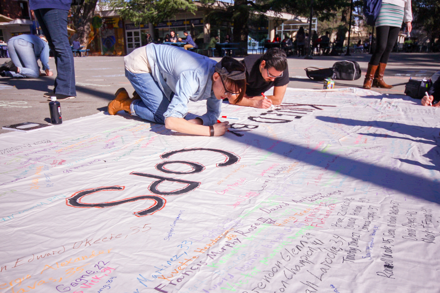 Students belonging to Black Lives Matter on campus held a protest last Wednesday, called "Say Their Name," at Memorial Union, to bring a awareness to the 1500 people who had been killed by police officers in 2015. The students organized to write the names in chalk and on a sheet to make it permanent. (ASHLEY LUGO / AGGIE)