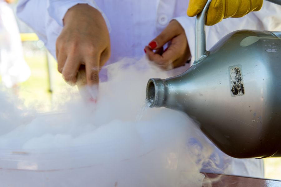 Students in clad in lab coats stir vigorously as the liquid nitrogen evaporates over their mixture of milk and chocolate. (ANH-TRAM BUI)