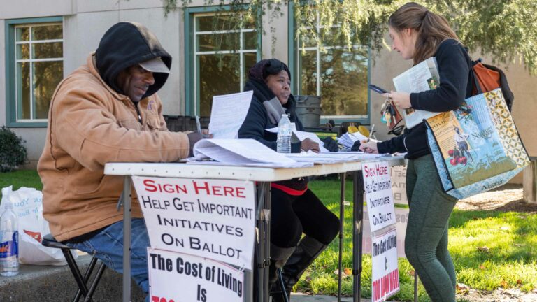 “The cost of living is too damn high!” Petition circulators outside Shields Library tell their story