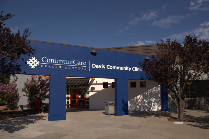 An outside view of the blue CommuniCare Health Center's Davis Community Clinic building
