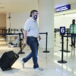 U.S. Senator Ted Cruz (R-TX) carries his luggage at the Cancun International Airport before boarding his plane back to the U.S., in Cancun
