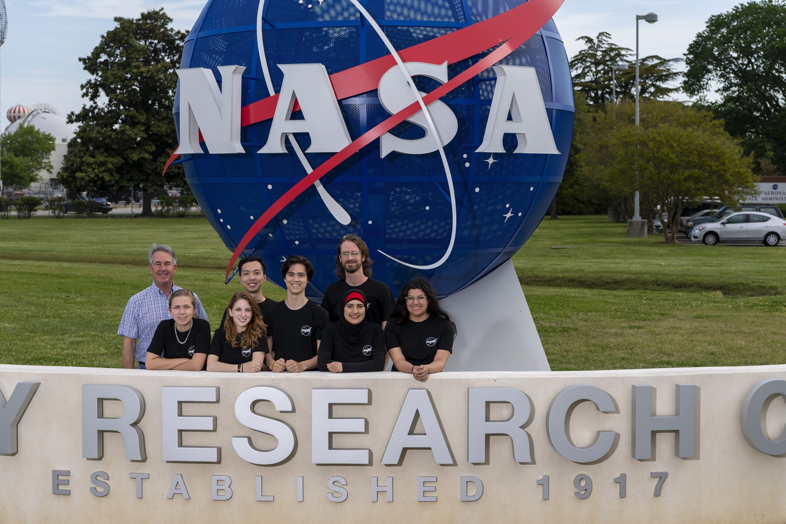 Students in front of a sculpture for the NASA research center